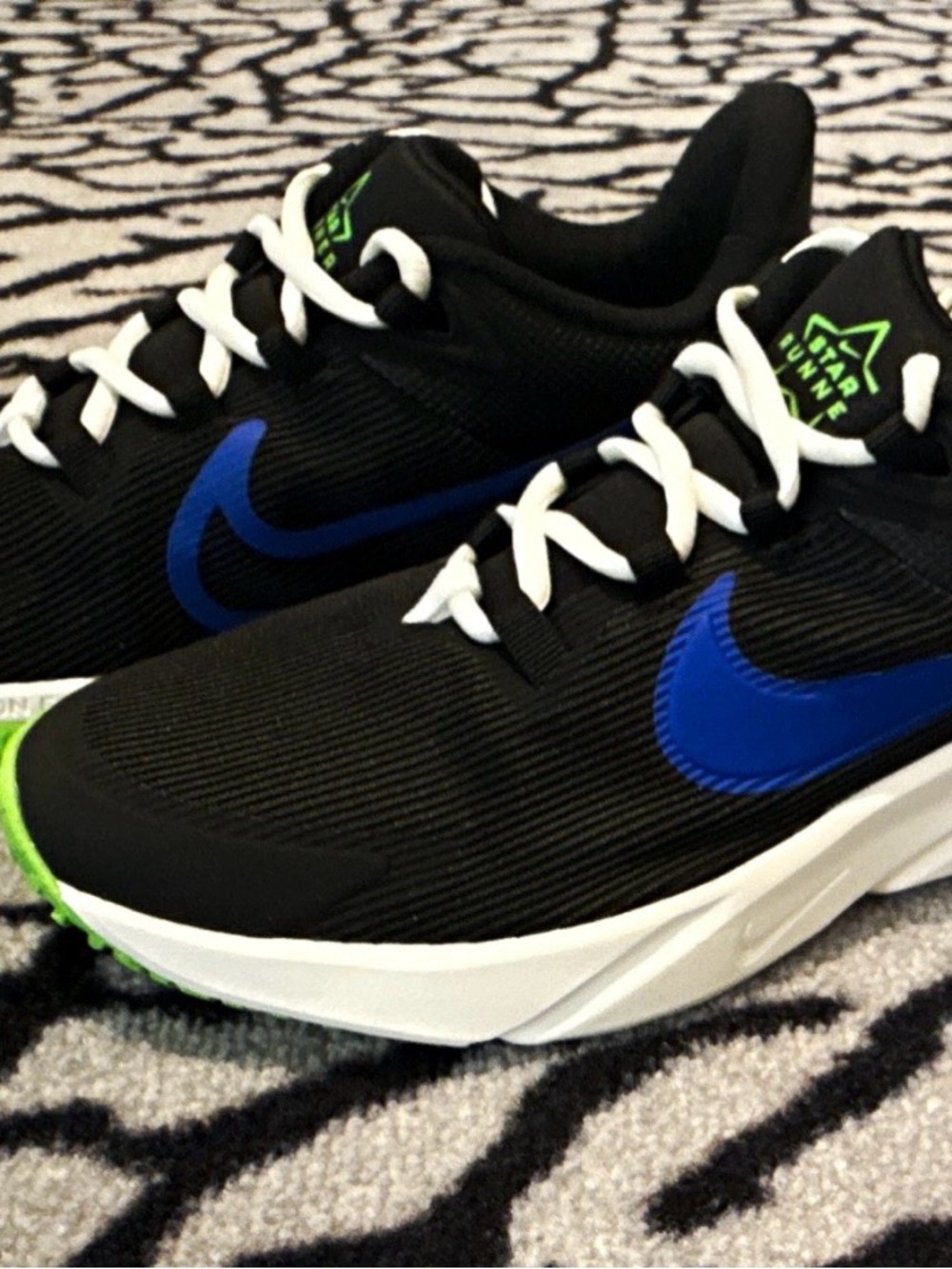Nike Kids Black Star Runner Shoes with Blue Swoosh and Green Accents